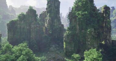 CGI Lush green rocks rise majestically in a serene, misty landscape at dawn video