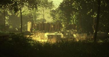 CGI Elegant outdoor dining setup surrounded by greenery at sunset video