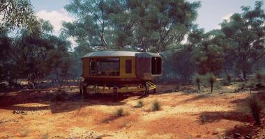 CGI Unique futuristic habitat surrounded by trees in an arid landscape video