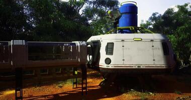 CGI Futuristic spacecraft near a lush forest during bright daylight hours video