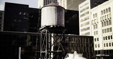 CGI Water tower stands tall against urban skyline in afternoon light video