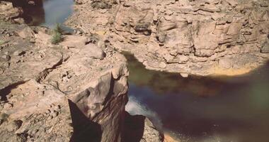 CGI Exploring the rocky canyon landscape with winding river at sunset video
