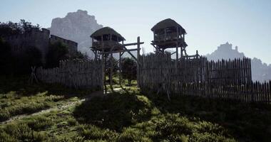 CGI Historic fortification with wooden towers set against a mountainous backdrop video