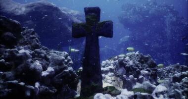 CGI Underwater cross discovered among coral and fish in ocean depth video