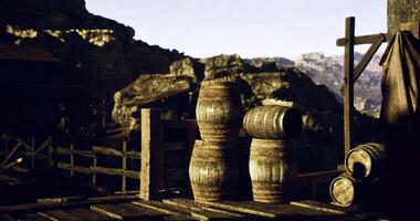 CGI Wooden barrels near a rustic wooden structure in a mountainous landscape video
