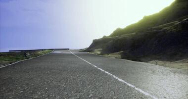 CGI Sunny road winding through mountainous landscape during midday conditions video
