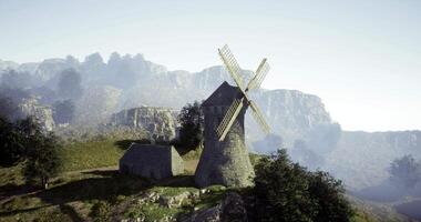 CGI Windmill stands tall against mountainous landscape during daylight hours video