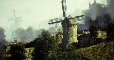 CGI Windmills and ancient castle overlooking lush landscape during misty dawn video