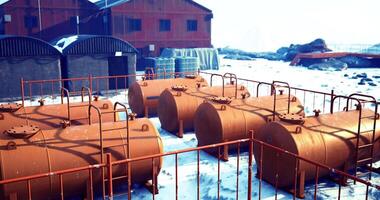 CGI Storage tanks sit on a snowy landscape near a building in a cold region video