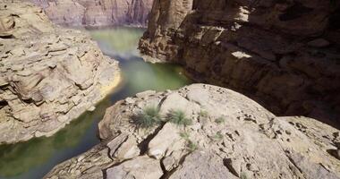 CGI Natural rock formations surround a serene river bend in a canyon video