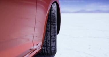 CGI Close up of a tire on a vehicle in a vast salt flat landscape video