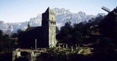 CGI Ancient stone church on hillside surrounded by mountains and windmills video