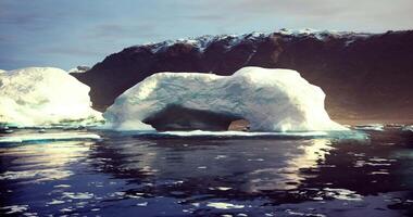 CGI Iceberg formation near dark mountain range at sunset in Arctic waters video