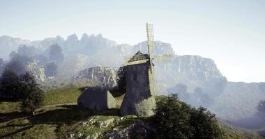 CGI Windmill on a hillside landscape with mountains in the background video