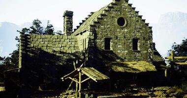 CGI Historic stone building with thatched roof surrounded by trees at noon video