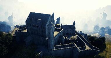 CGI Historic stone castle surrounded by fog and windmills at dawn video