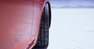 CGI Car tire on salt flat surface under clear sky during daylight hours video