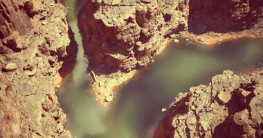 CGI River winding through rugged canyons under bright sunlight in a remote area video