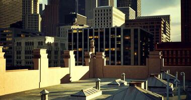 CGI Urban rooftop view of city skyline during dusk with buildings in background video