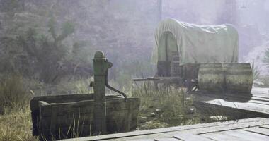 CGI Wooden water pump and wagon in a dusty, sunlit desert landscape video