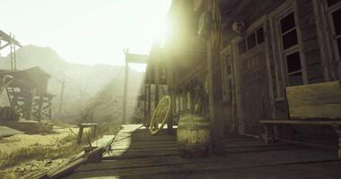 CGI Historic wooden building in a ghost town with a sunlit desert landscape video