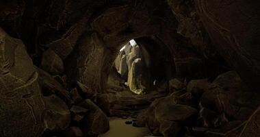 CGI Exploration of a dark cave with light illuminating rocky formations video