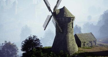 CGI Historic windmill stands majestically on a hillside during early morning fog video