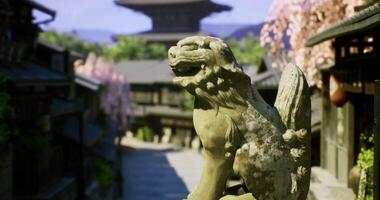CGI Ancient lion statue overlooking a quiet street lined with cherry blossoms video