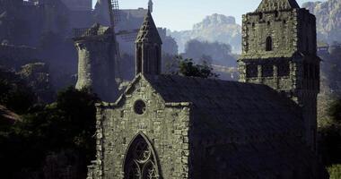 CGI Ancient stone church overlooking a medieval village at sunrise video