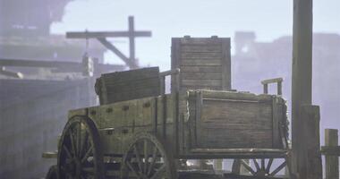 CGI Old wooden cart resting in a misty harbor during early morning hours video