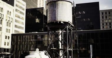 CGI Urban water tower stands tall among skyscrapers in downtown area video