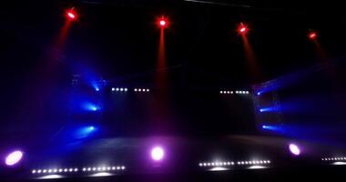 CGI Colorful stage lights illuminate a dark venue preparing for a performance video