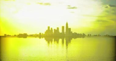 CGI Bright sunset view over a city skyline reflecting on calm waters video