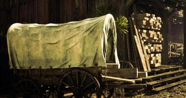 CGI Wagon with a canvas cover beside wooden stacks in a rustic setting video