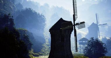 CGI Windmills stand proudly in a serene landscape with morning mist and mountains video