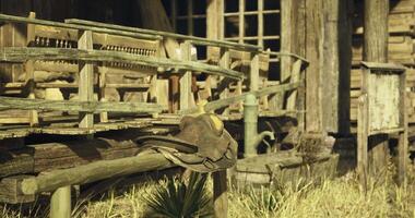 CGI Rustic saddle resting on weathered porch of an old western building video