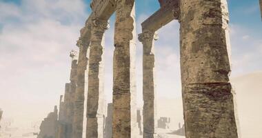 CGI Ruins of ancient columns stand against a cloudy sky in desert landscape video
