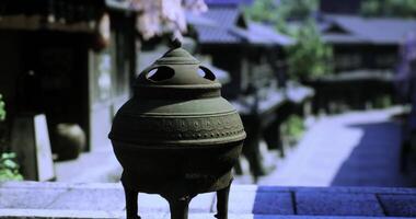 CGI Historic metal incense burner in a traditional Japanese village setting video