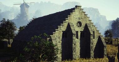 CGI Historic stone structure by a windmill in a serene natural setting video