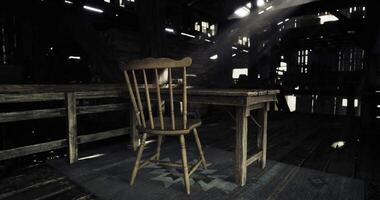 CGI Abandoned room with rustic chair and table in dimly lit barn setting video