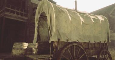 CGI Old covered wagon parked near wooden barrels in a rustic setting video