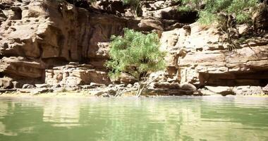 CGI Tranquil waters reflect rugged cliffs in a serene natural oasis video