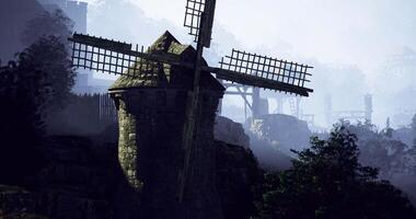 CGI Historic windmill stands amidst misty mountains in serene landscape view video