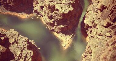 CGI Stunning view of a winding river surrounded by rocky cliffs in a canyon video