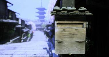 CGI Old wooden mailbox beside cobblestone path with pagoda in background video