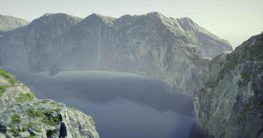 CGI Stunning view of a serene lake surrounded by towering cliffs in nature video
