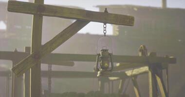 CGI Rustic lantern hanging in an old wooden structure at dawn video