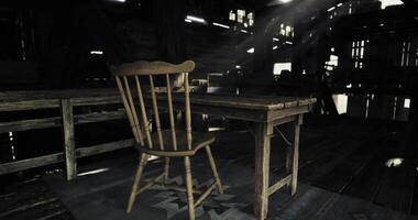 CGI Old wooden chair beside a rustic table in a dimly lit barn space video