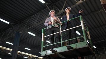 Business woman and warehouse workers are reviewing the list of items based on the documentation,137 photo