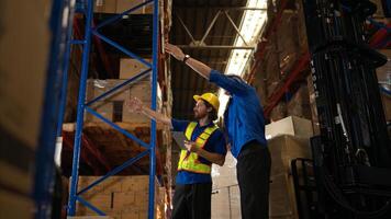 A bunch of warehouse workers are reviewing the list of items based on the documentation,88 photo
